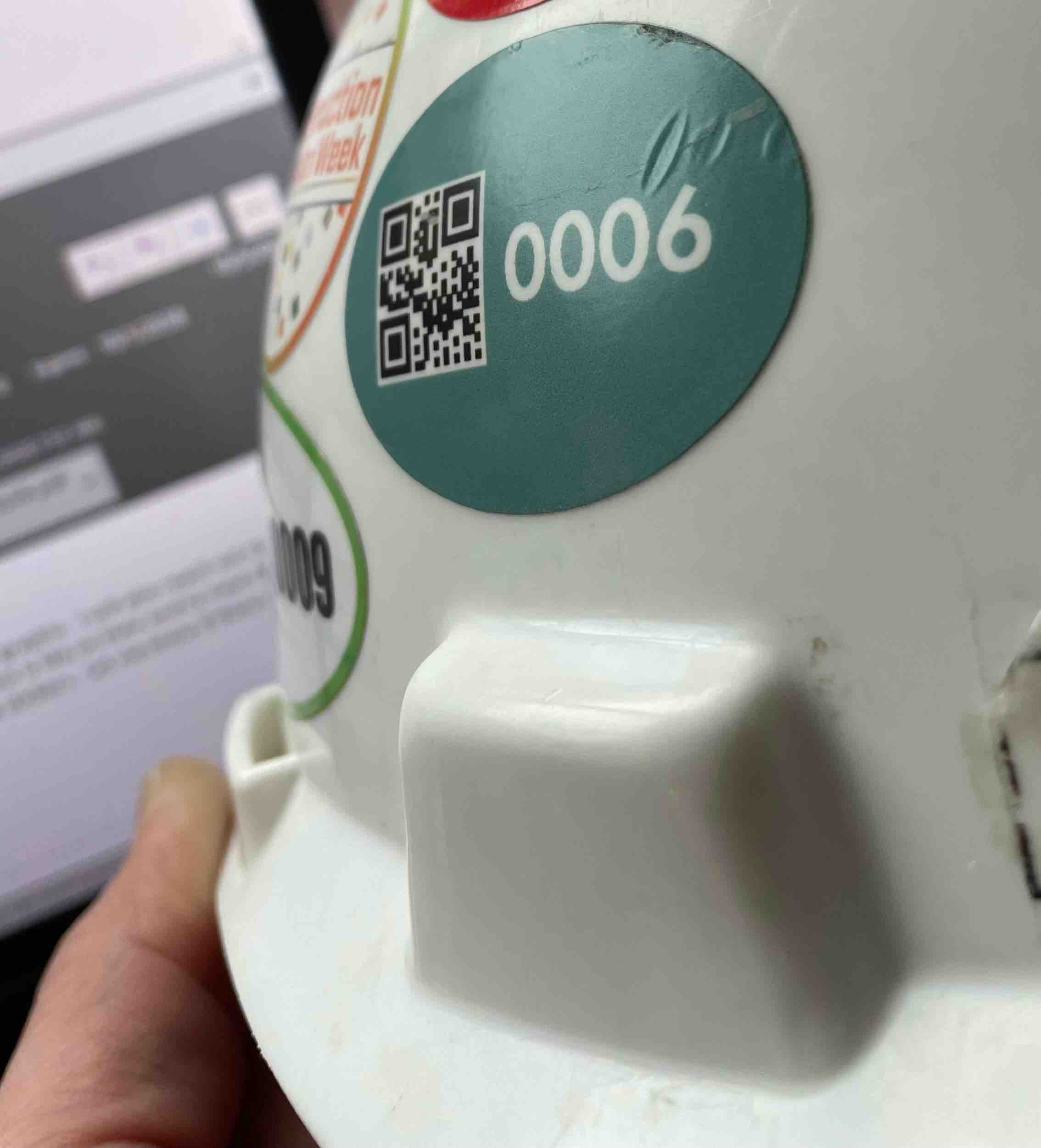 The QR code on each worker's hard hat is scanned each day.